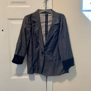 Denim appearing vest jacket. Fake pockets, one button hole in front.
